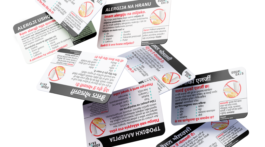 Equal Eats black, white, and red allergy translation cards falling against a white background